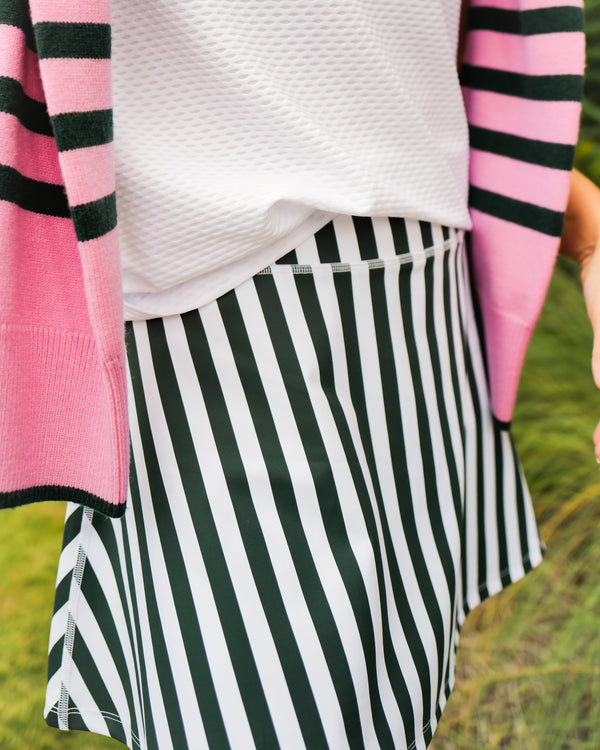 Model is wearing the everyday skort in inverse cerulean dottie with the everyother day crewneck in white.