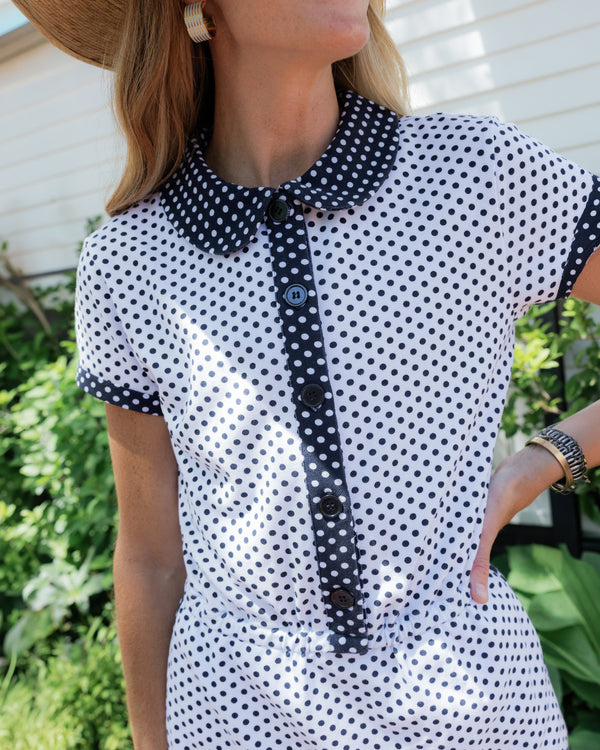 Model is wearing the lennon romper in super white navy dottie