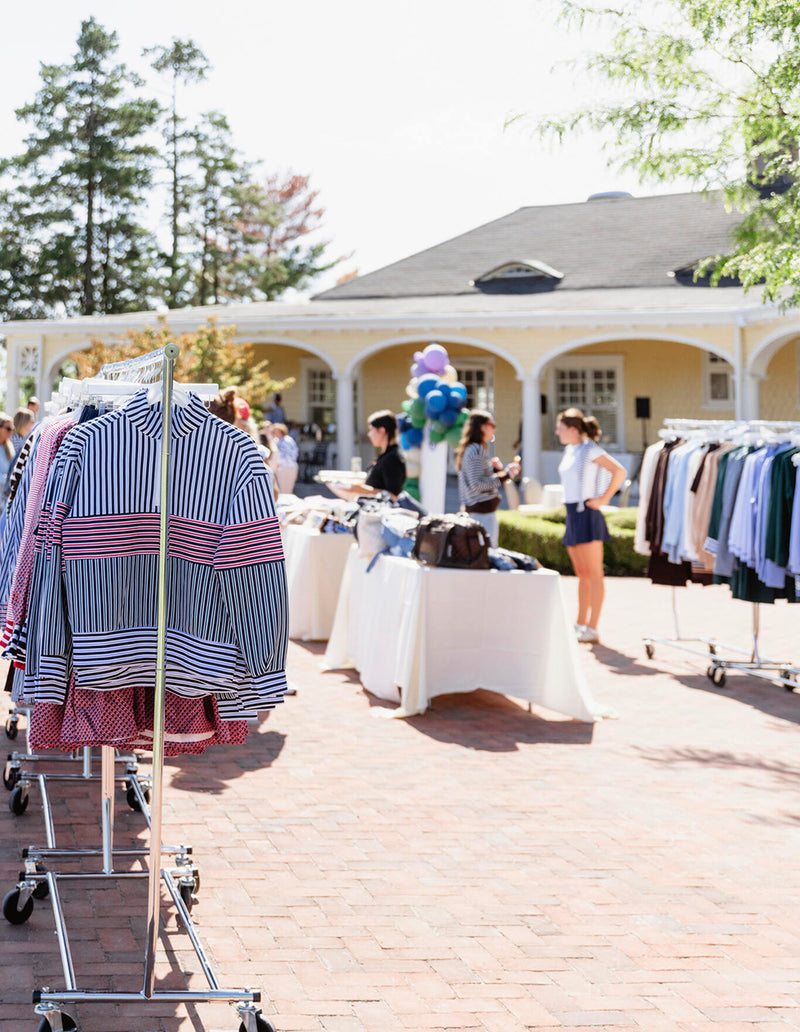 Fall 24 clothes set up for guests to shop at the 6th birthday party