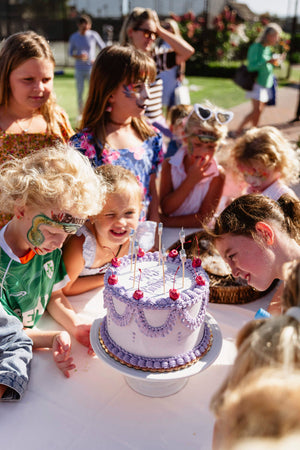 Birthday cake and guests at the AB 6th birthday party