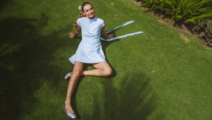Model is wearing the Everglade Dress in Baby Blue/ Super White Triple Stripe
