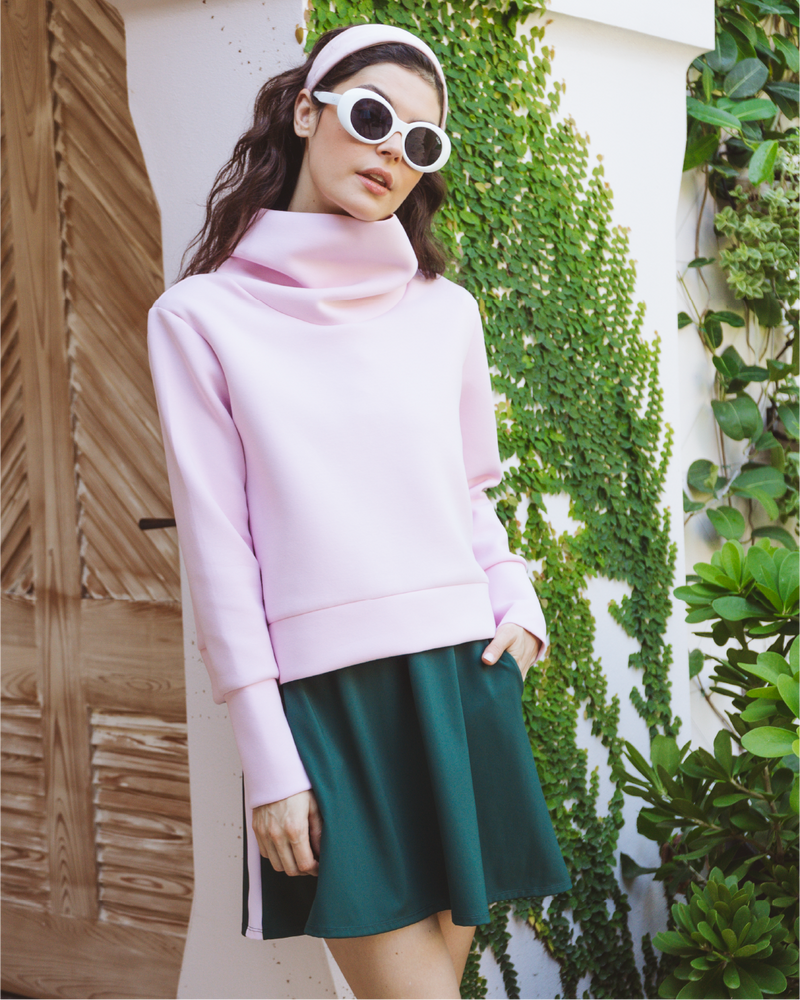 Model is wearing the Everyother Day Pullover in Petal over the Everglade Dress in Ivy
