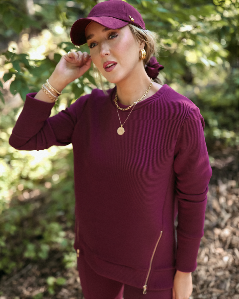 Mary Orton is wearing the Everyday Crewneck in Burgundy with the Nico Pant in Burgundy.