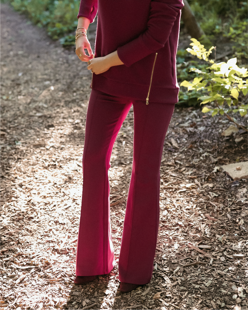 Mary Orton is wearing the Nico Pant in Burgundy with the Everyday Crewneck in Burgundy.