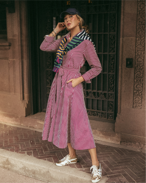 Mary Orton is wearing the Coco Dress in Burgundy/ Ivory Stripe with the Varsity Quarter Zip in Mary Multi around her shoulders.