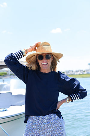 Marghi is wearing the Penny Pullover in Navy and the Flounce Skort in Matisse Geo