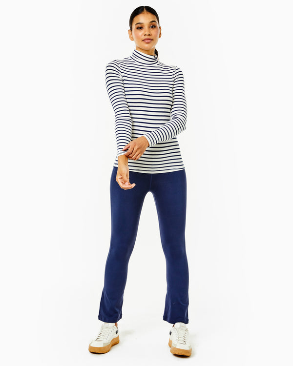'On model product image of Rib Light Everyday Ribbed Turtleneck Long Sleeve in Off White/Navy Stripe'