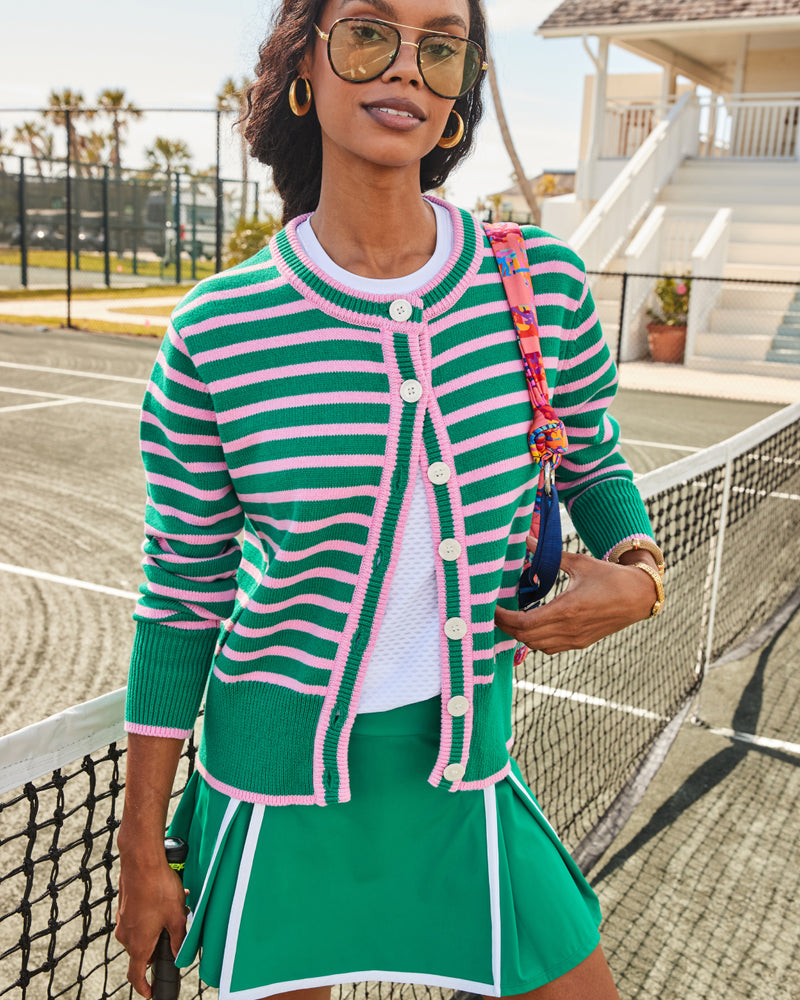 Model is wearing the Palmetto Short Sleeve in Super White under the Coastal Cardigan in Greenbrier/Bubblegum Stripe with the Gardenia Skort in Greenbrier