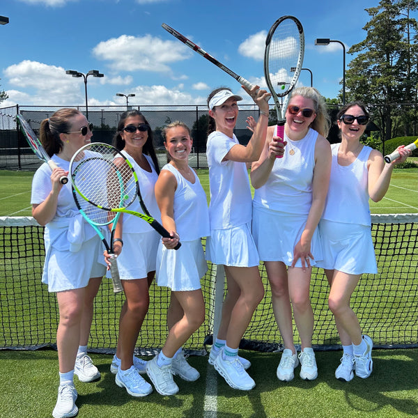 Models are wearing smooth sport flounce skort in super white paired with the active mesh everyother day tank in super white. 