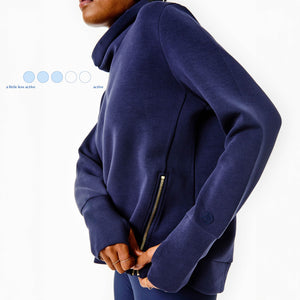 Model is wearing the Everyday Pullover in Navy with the AB Soft Legging in Navy Blue