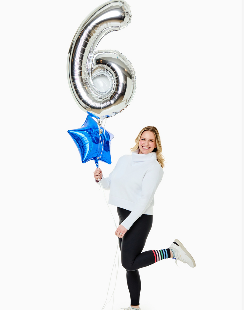 Model is wearing the Everyother Day Pullover in Super White with the Everyday Legging in Black/Poppy/Petal Stripe