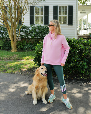 Model is wearing the he everyday quarter zip in bubblegum paired with the spruce legging in ivy/super white/ballet slipper/bubblegum 
