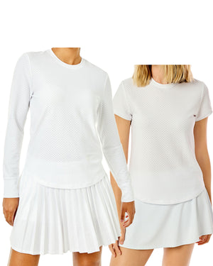 Model on the left is wearing the palmetto long sleeve in super white paired with Clubhouse Skort in super white. Model on the right is wearing palmetto short sleeve paired with flounce skort in super white