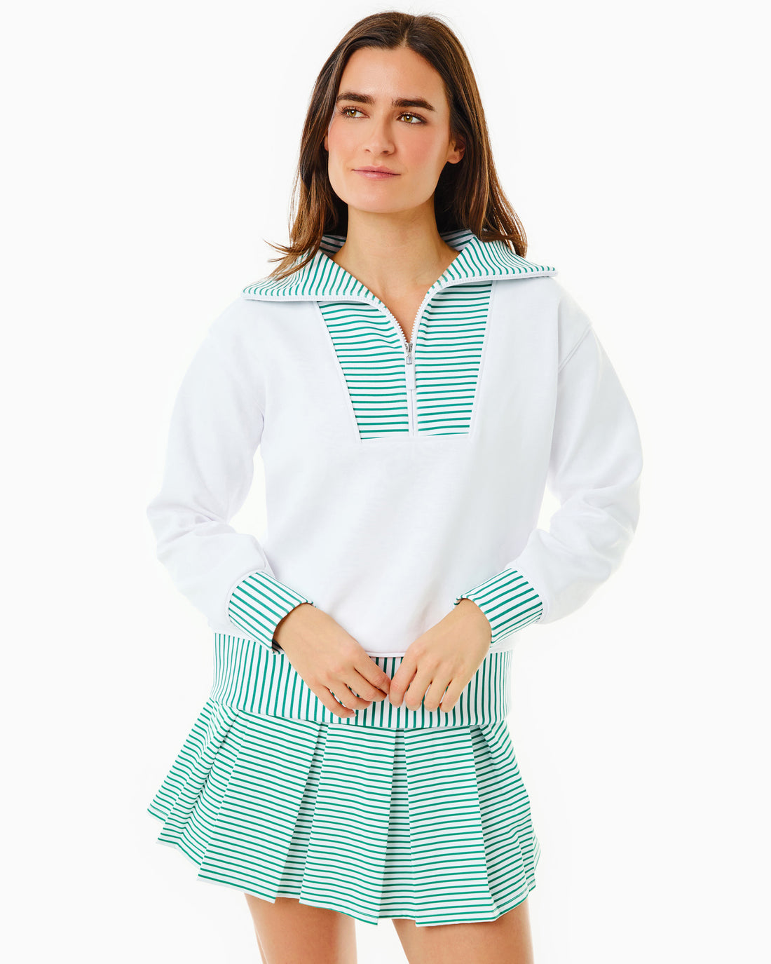 Model is wearing the Alley Quarter Zip in Super White with the Racquet Skort in Super White/ Greenbrier Stripe