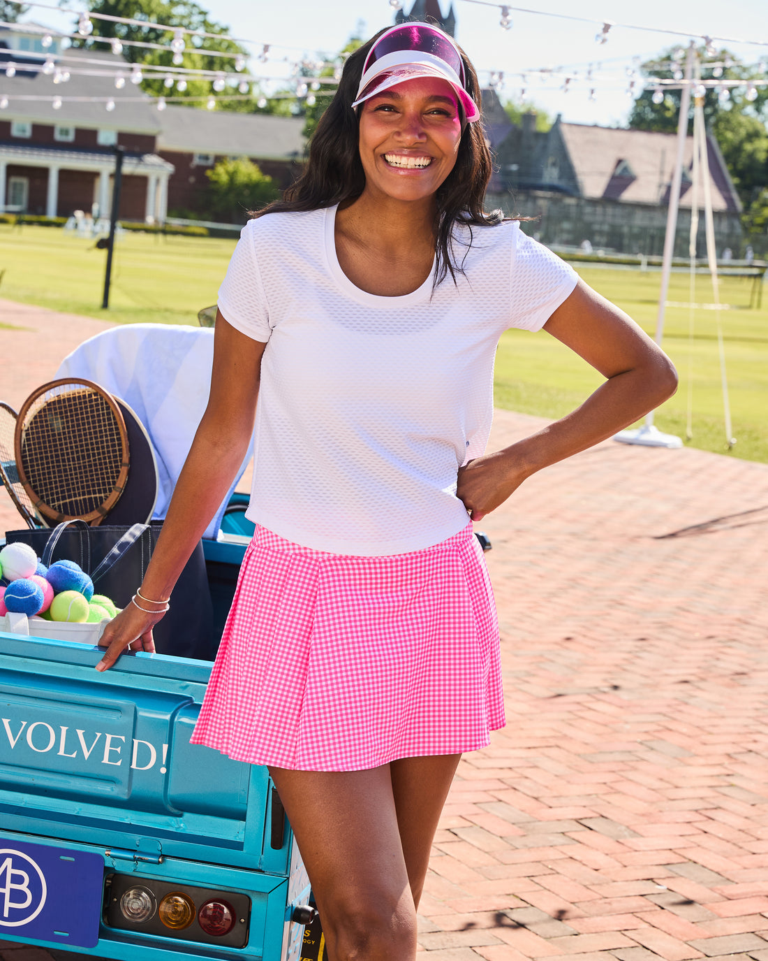 Model is wearing the sport light baseline skort in violet paired with the active mesh walnut short sleeve in violet. 
