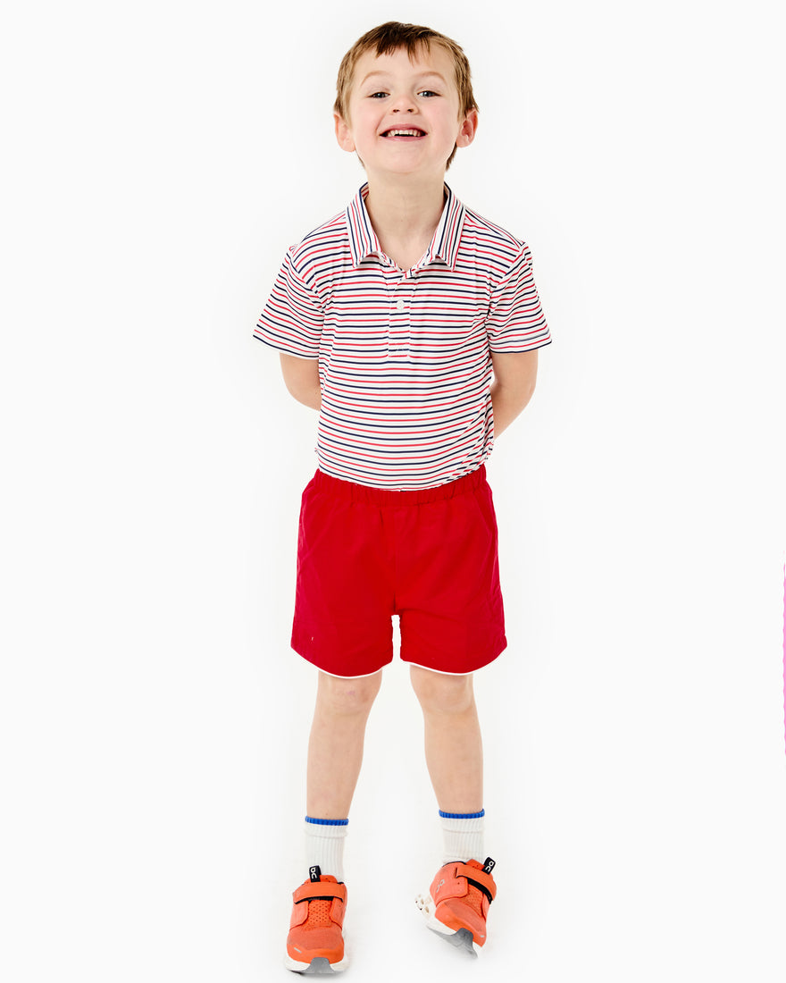 Child model is wearing the Behr Set in Cerulean blue stripe.