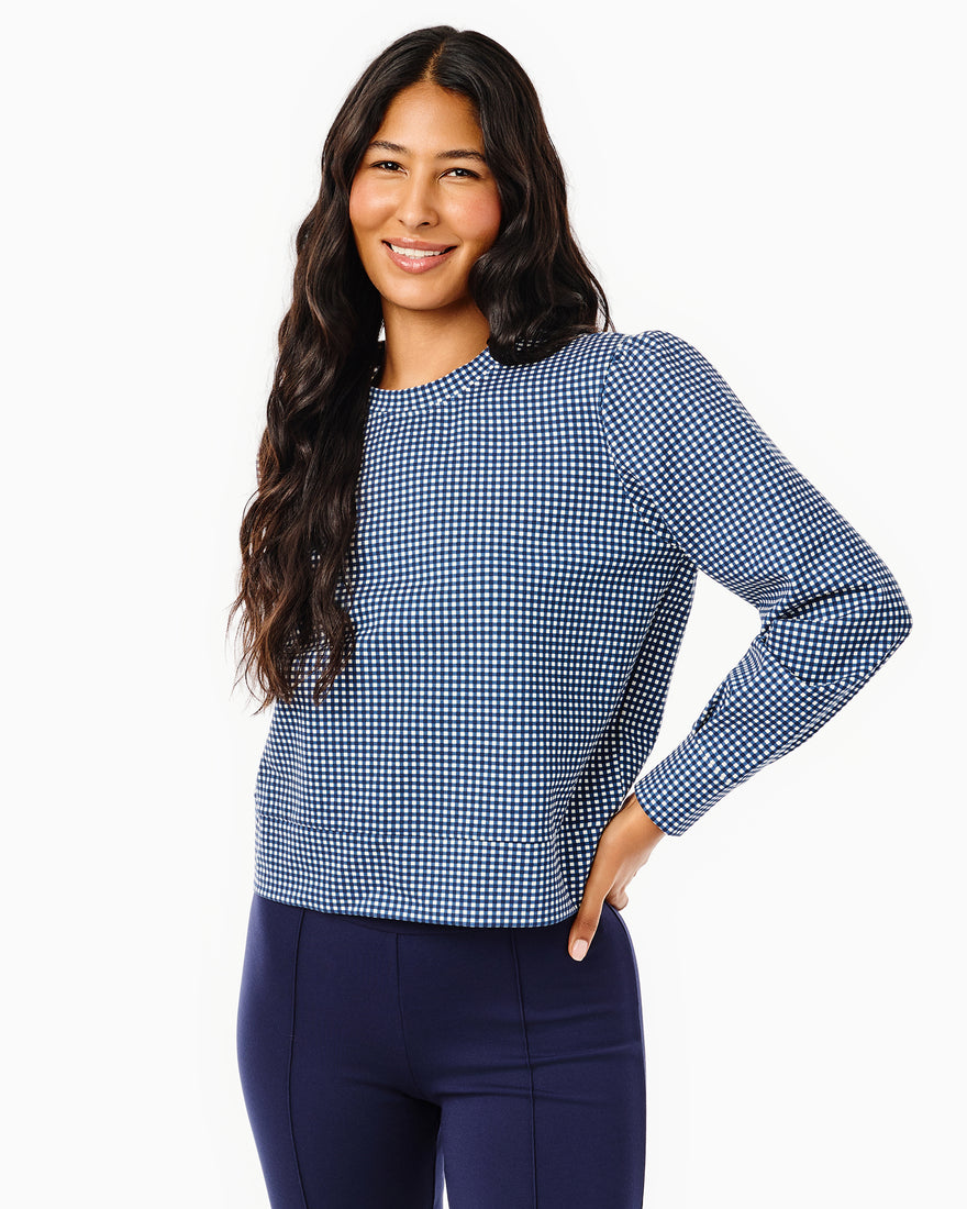 Model is wearing the beta bow pullover in navy gingham.
