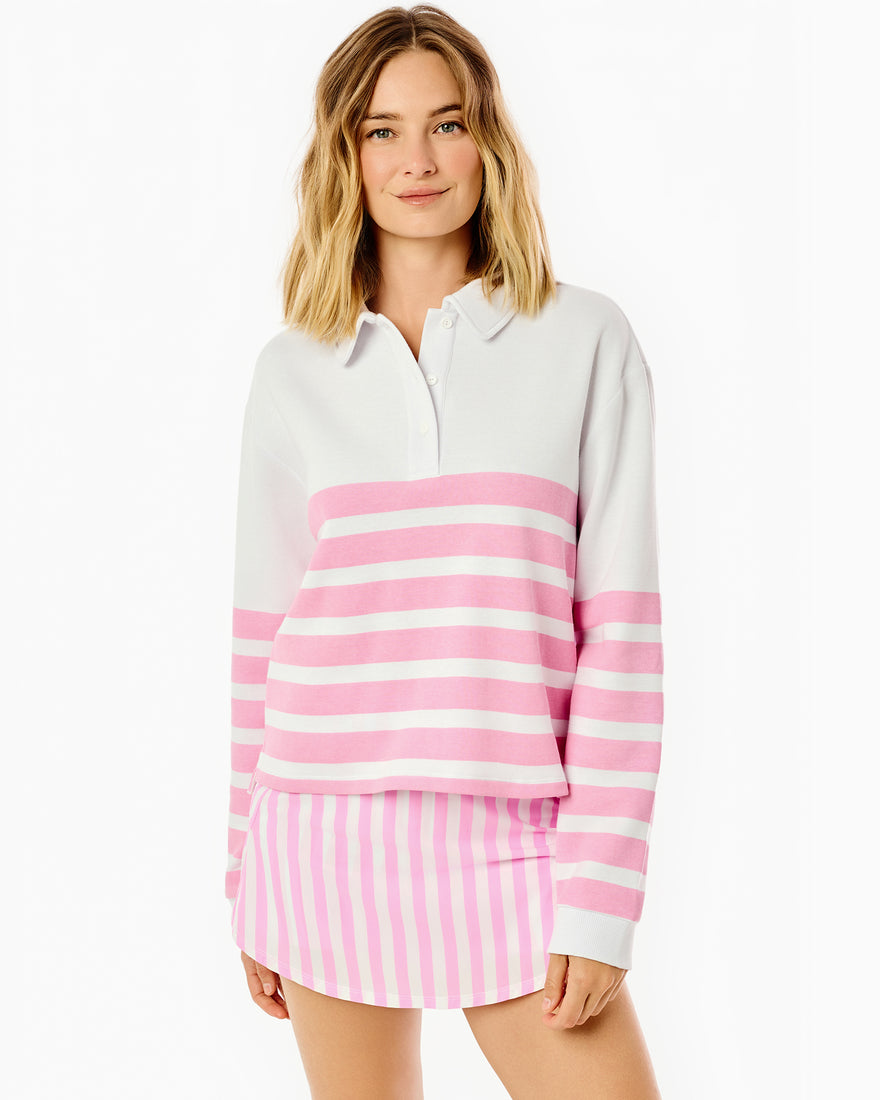 Model is wearing the betty rugby in bubblegum cabana stripe paired with the everyday skort in bubblegum cabana stripe