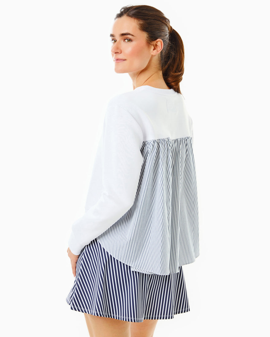 Model is wearing the Bloom Pullover in Super White with the Flounce Skort in Navy/Super White Stripe