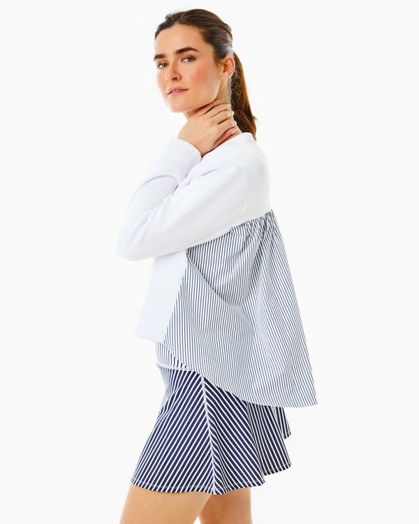 Model is wearing the Bloom Pullover in Super White with the Flounce Skort in Navy/Super White Stripe