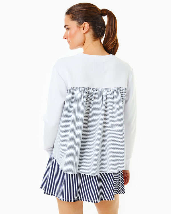 Model is wearing the Bloom Pullover in Super White with the Flounce Skort in Navy/Super White Stripe