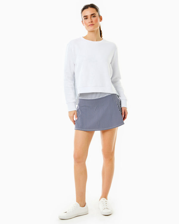 Model is wearing the Bloom Pullover in Super White with the Flounce Skort in Navy/Super White Stripe