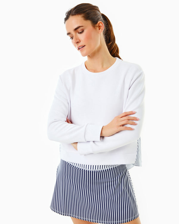 Model is wearing the Bloom Pullover in Super White with the Flounce Skort in Navy/Super White Stripe
