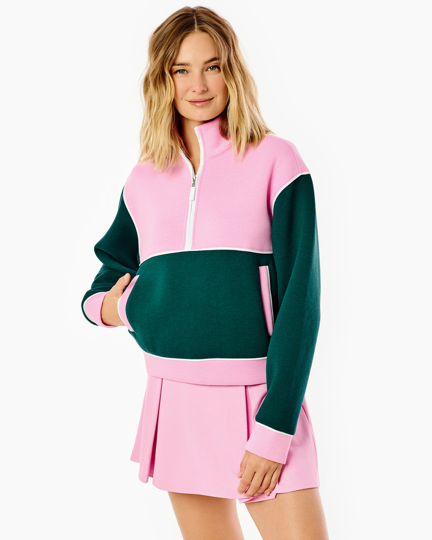 Model is wearing the breakpoint quarter zip in bubblegum/ivy paired with the breakpoint skort in bubblegum/ivy