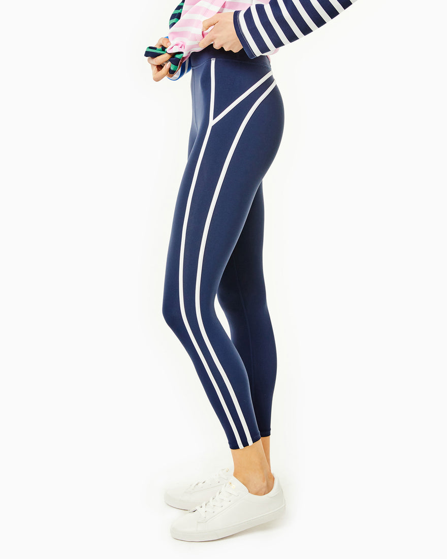Side shot of the model wearing the Chestnut legging in Navy with the Delancey pullover in Multi stripe.