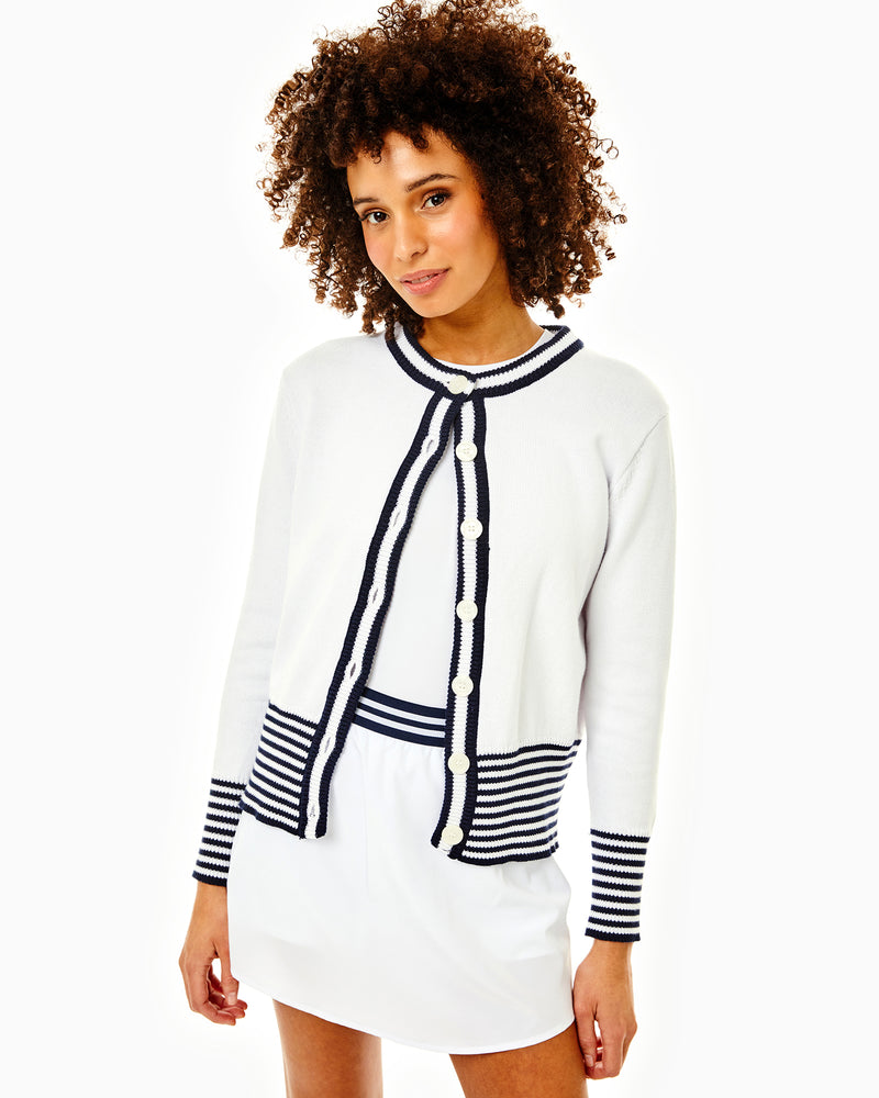 Model is wearing the coastal cardgian in super white with the scout skort in white with the everyday tank in white.