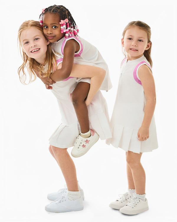 'On model product image of Delaney Tennis Dress X Cecil & Lou in Super White/Bubblegum'
