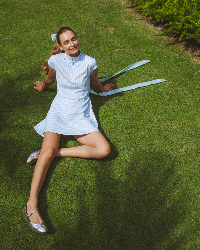 Model is wearing the Everglade Dress in Baby Blue/Super White Triple Stripe