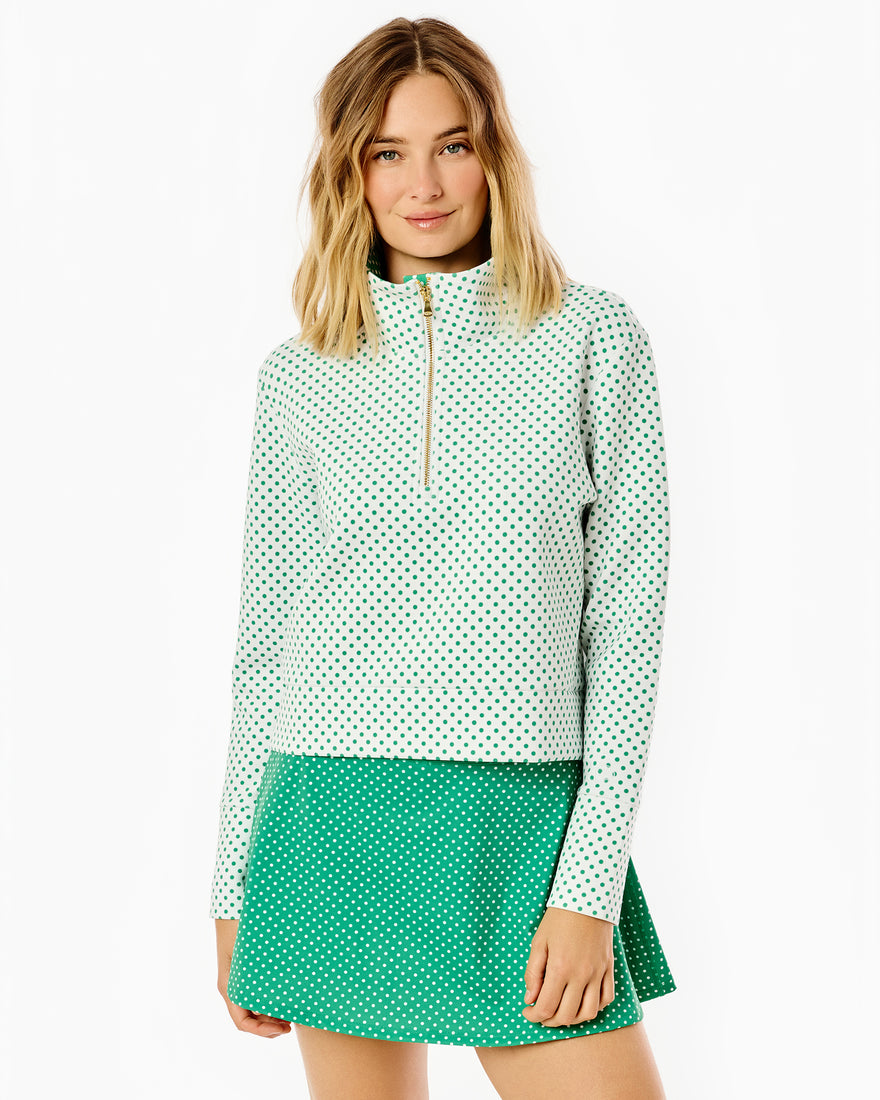 Model is wearing the everyother day quarter zip in palm dottie paired with the flounce skort in inverse palm dottie