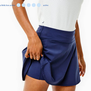 Model is wearing the Walnut Short Sleeve in Super White with the Flounce Skort in Navy