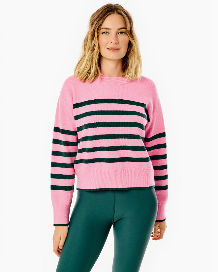 Model is wearing the junior Carlyle crewneck sweater in lavender/violet stripe paired with the spruce legging in navy/super white/violet/lavender.