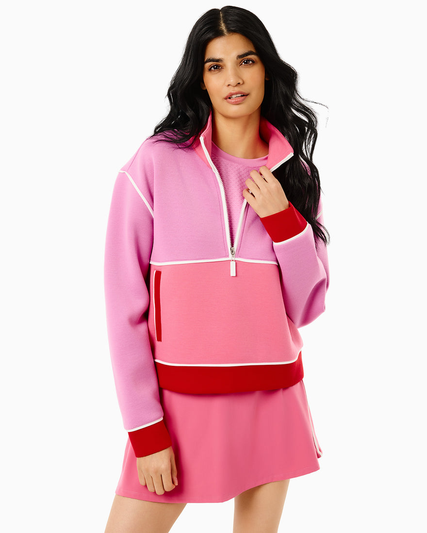 Model is wearing the breakpoint quarter zip in bubblegum/ivy paired with the breakpoint skort in bubblegum/ivy