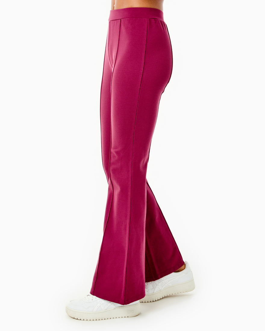 Model is wearing the Nico Pants x Mary Orton in Burgundy with the Kitt Sweater x Mary Orton in Burgundy/ Off-White Stripe