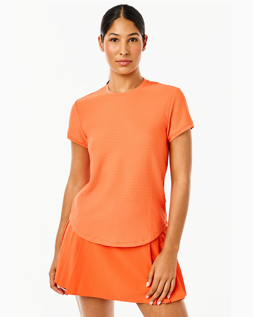 Model is wearing the Palmetto Short Sleeve in Super White with the Flounce Skort in Navy/Super White Stripe 