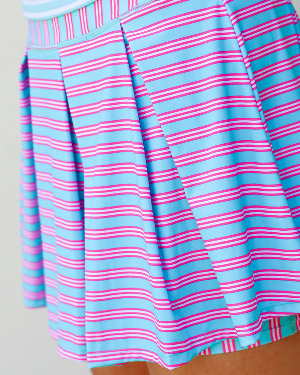 'On model product image of Smooth Sport 14in Pleated Racquet Skort in Mint/Bright Pink Triple Stripe'
