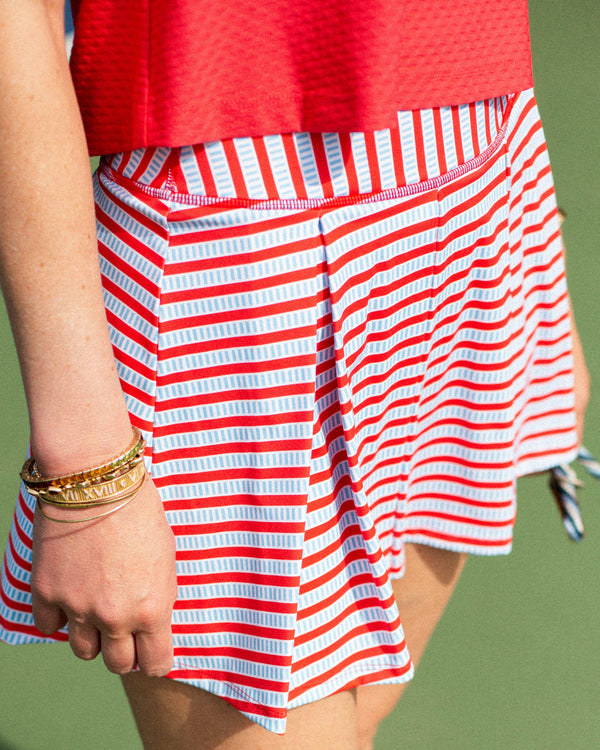 'On model product image of Smooth Sport 14in Pleated Racquet Skort in Ruby Hatch'