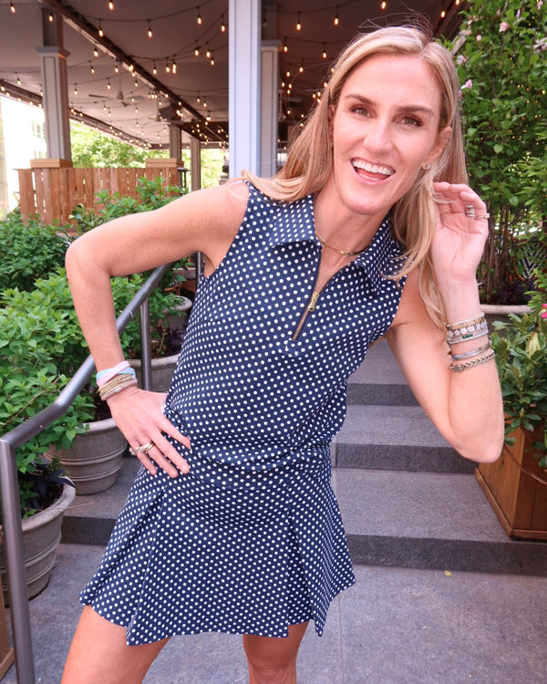 'On model product image of Ponte Sleeveless Virginian Polo in Navy Dottie'