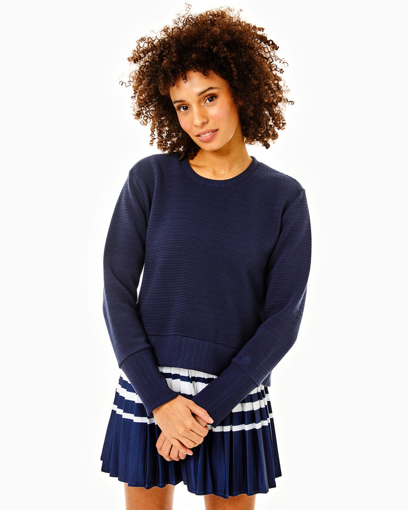 Model is wearing the everyother day crewneck in navy with the clubhouse skort in navy white stripe.