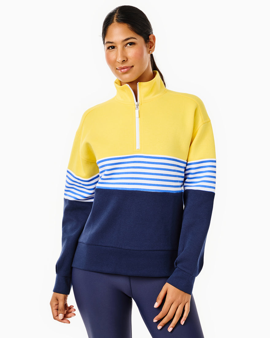 the model is wearing varsity quarter zip in petal multi stripe with the everyday skort in petal/ peony stripe