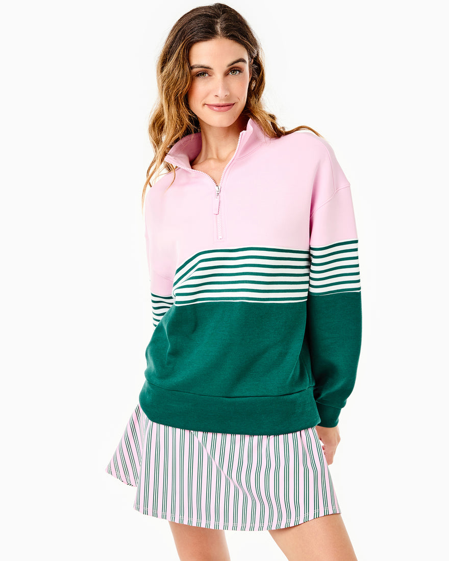 the model is wearing varsity quarter zip in petal multi stripe with the everyday skort in petal/ peony stripe