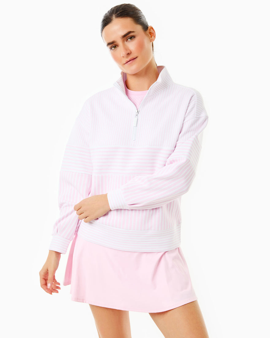 the model is wearing varsity quarter zip in petal multi stripe with the everyday skort in petal/ peony stripe