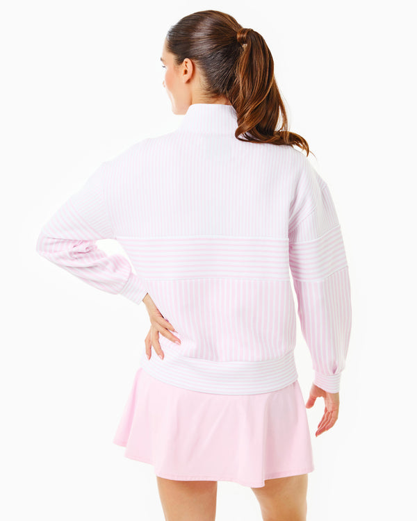 Model is wearing the Varsity Quarter Zip in White/Petal Stripe over the Walnut Short Sleeve in Petal with the Flounce Skort in Petal
