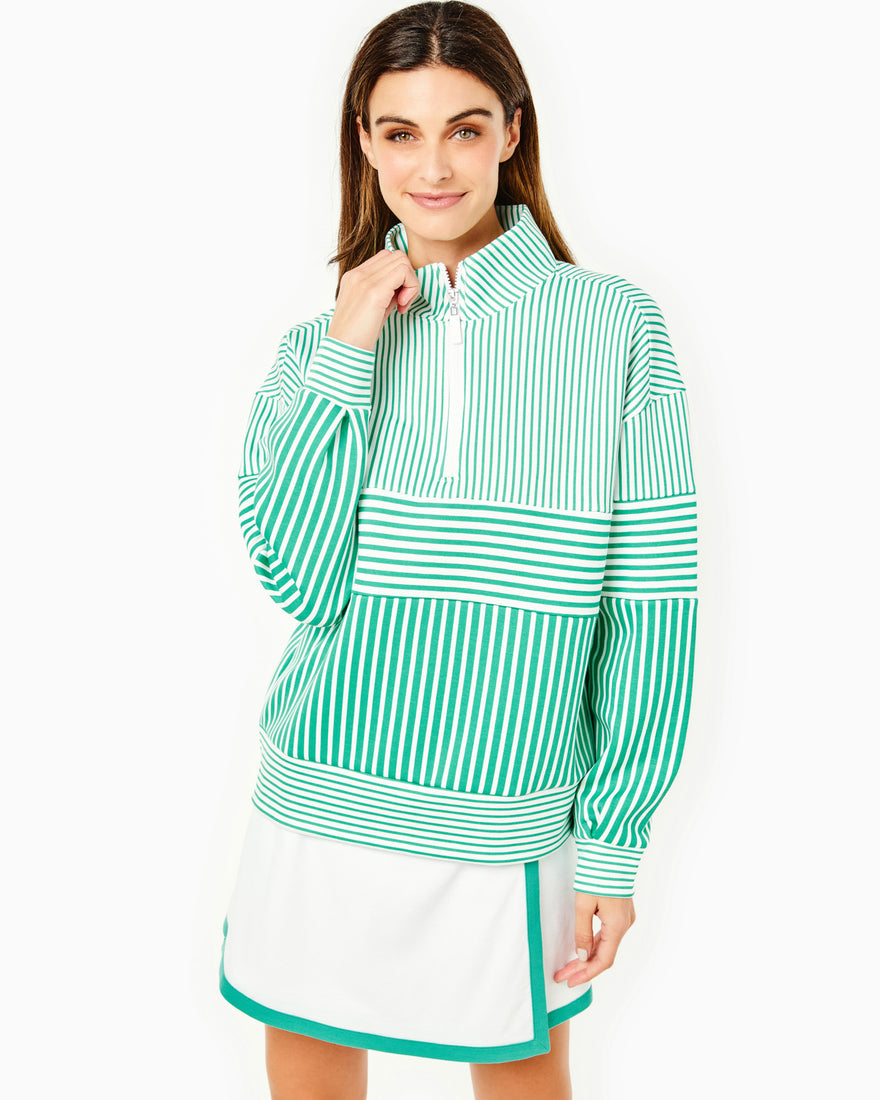 Model is wearing the Varsity Quarter Zip in palm stripes with the Beatrice Skort in white