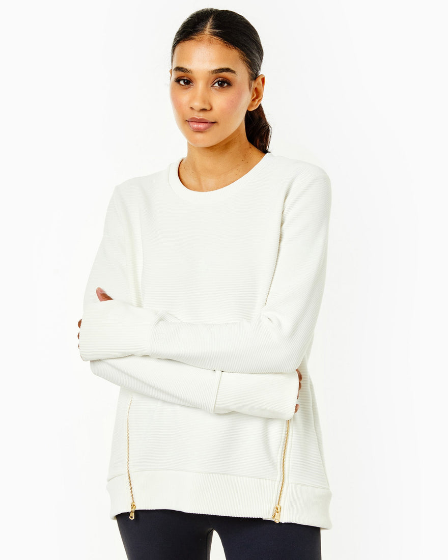 Model is wearing the everyday crewneck. This style features a pull on style, ribbed fabrication with zipper details on body and thumb holes at sleeve cuff. This is in solid black and paired back with the everyday active legging in black.