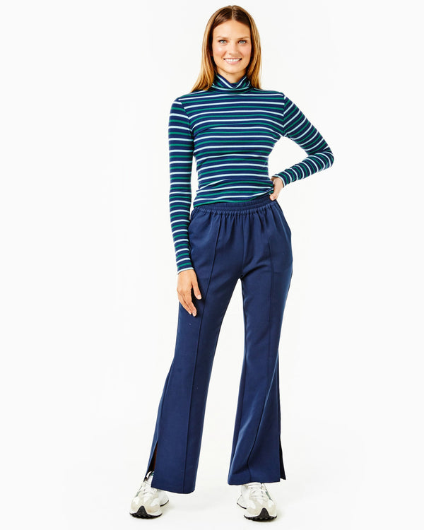 Model is wearing the Everyday Ribbed Turtleneck in Navy, Mint and Olive Stripes with the Twiggy Pant in Navy